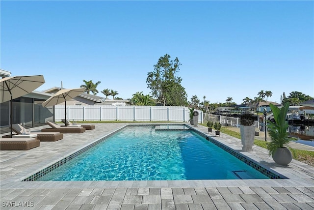 view of pool with a fenced backyard, a fenced in pool, and a patio