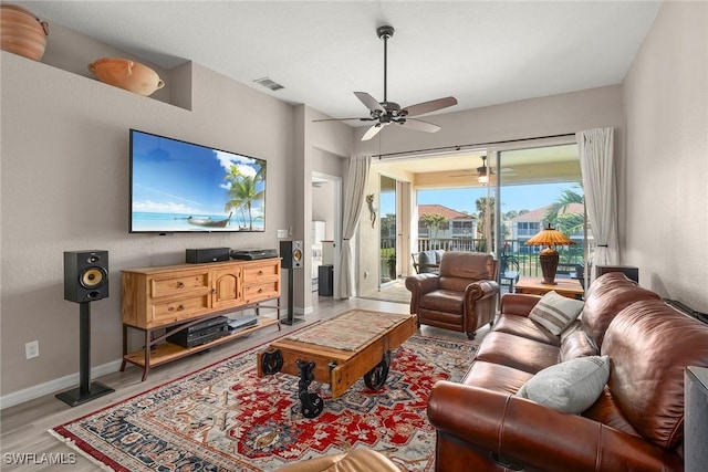 living room featuring light hardwood / wood-style floors and ceiling fan