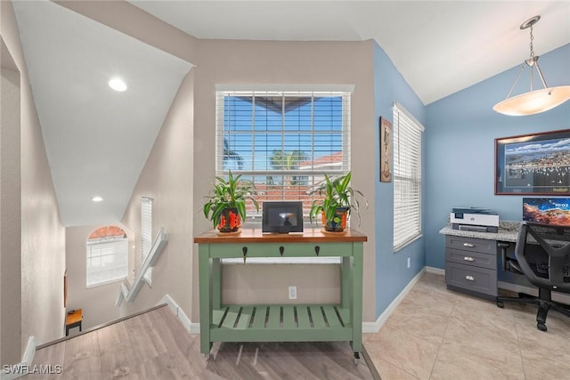 office area with light hardwood / wood-style flooring and vaulted ceiling