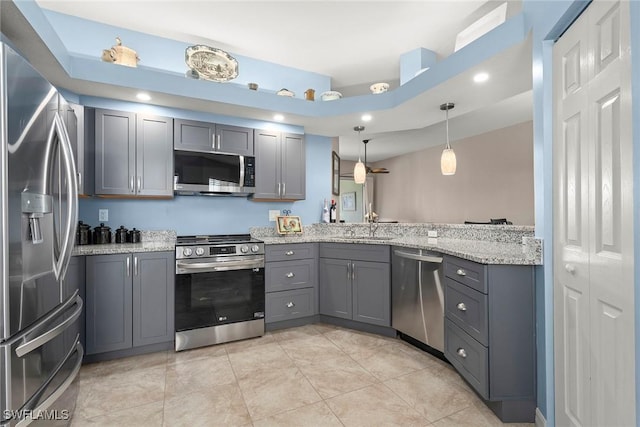 kitchen featuring gray cabinetry, sink, decorative light fixtures, and stainless steel appliances