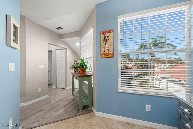 hallway featuring light tile patterned floors