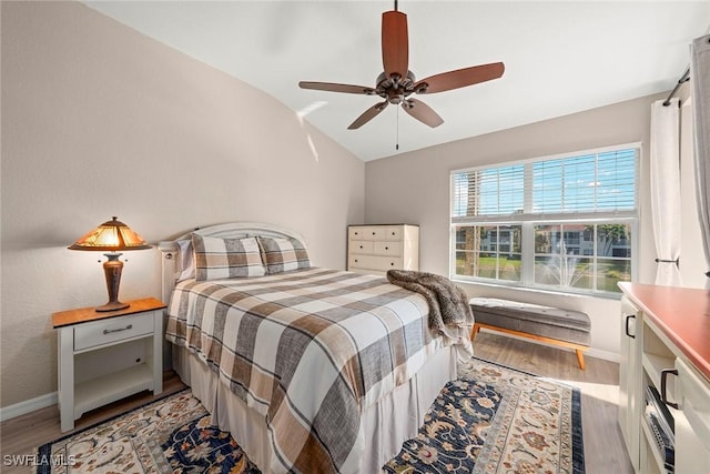 bedroom with lofted ceiling, hardwood / wood-style floors, and ceiling fan