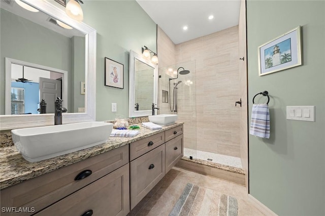 bathroom with vanity, tile patterned floors, and tiled shower