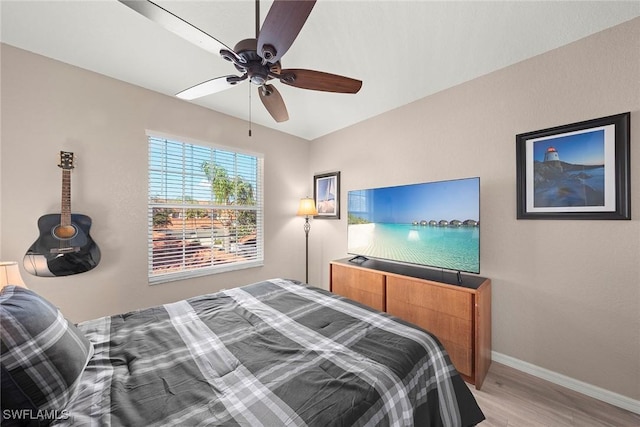 bedroom with light hardwood / wood-style flooring and ceiling fan