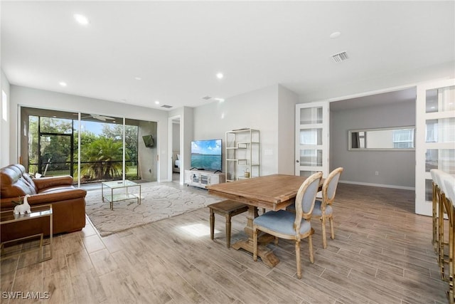 dining space with light hardwood / wood-style floors