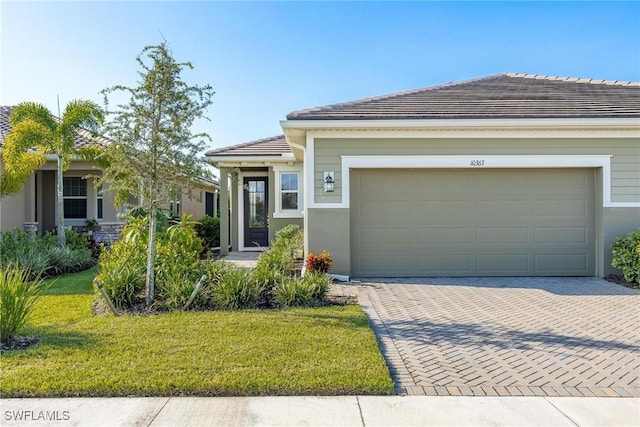 view of front of property featuring a garage and a front yard