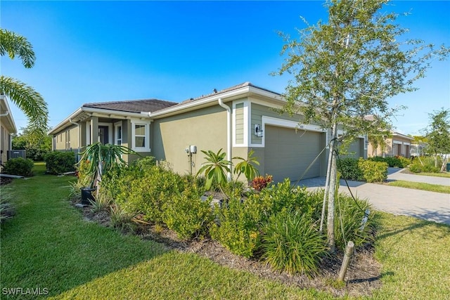 view of home's exterior featuring a garage and a yard