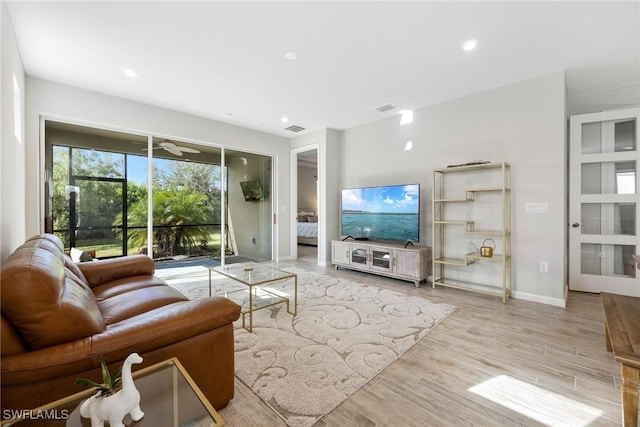 living room featuring ceiling fan and light wood-type flooring