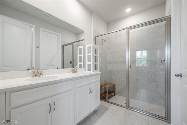 bathroom featuring vanity, tile patterned floors, and walk in shower