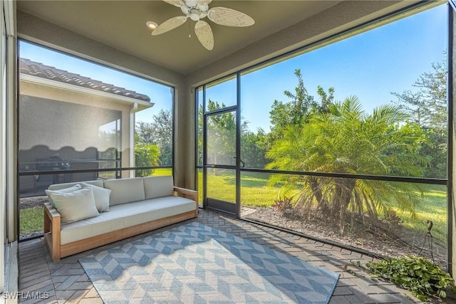 sunroom / solarium featuring ceiling fan