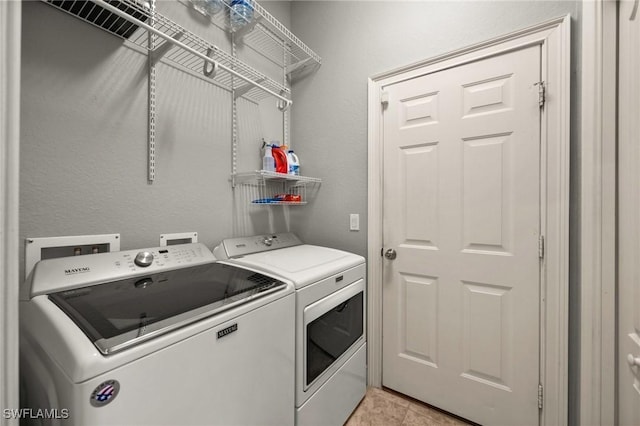 clothes washing area with washer and dryer