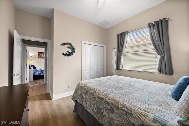 bedroom with ceiling fan, light hardwood / wood-style floors, and a closet