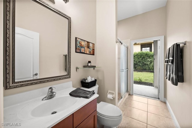 bathroom with tile patterned flooring, vanity, toilet, and a shower with shower door