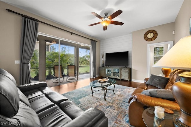 living room featuring hardwood / wood-style flooring, a wealth of natural light, and ceiling fan