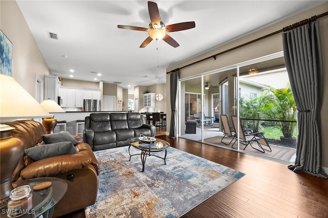 living room featuring dark hardwood / wood-style flooring and ceiling fan