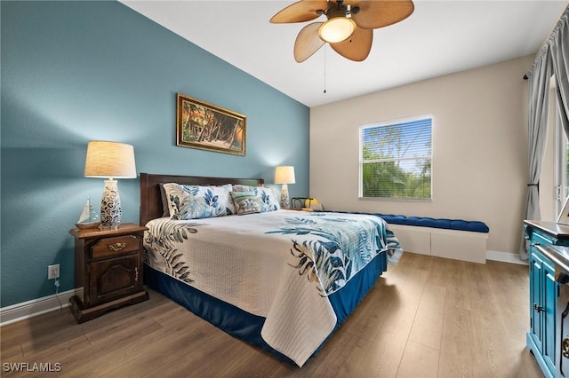 bedroom with ceiling fan and light hardwood / wood-style flooring