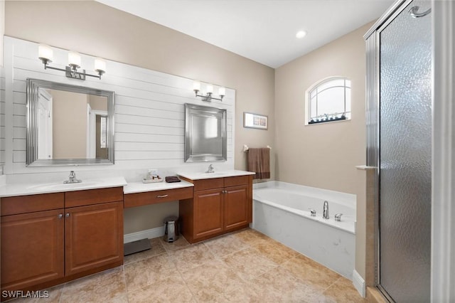 bathroom featuring vanity and independent shower and bath