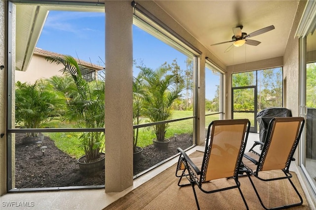 sunroom featuring ceiling fan