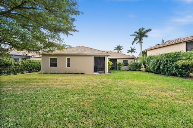 back of property featuring a lawn