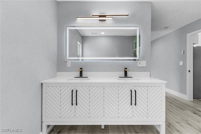 bathroom featuring vanity and wood-type flooring