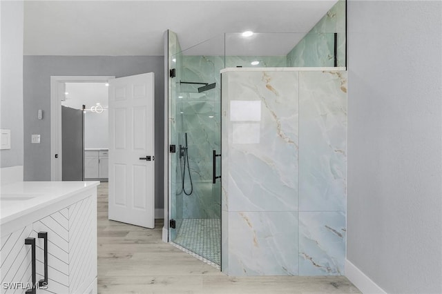 bathroom featuring vanity, hardwood / wood-style flooring, and walk in shower