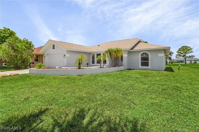 single story home with a garage and a front lawn