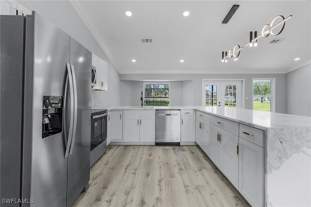 kitchen with white cabinetry, ornamental molding, appliances with stainless steel finishes, and kitchen peninsula