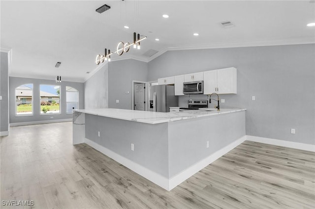 kitchen with white cabinetry, decorative light fixtures, ornamental molding, appliances with stainless steel finishes, and kitchen peninsula