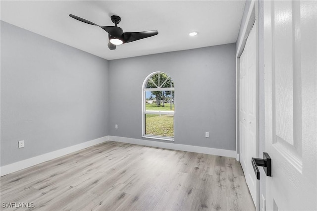 spare room featuring light hardwood / wood-style floors and ceiling fan