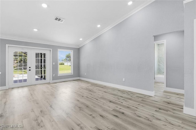 unfurnished room featuring crown molding, light hardwood / wood-style floors, and french doors