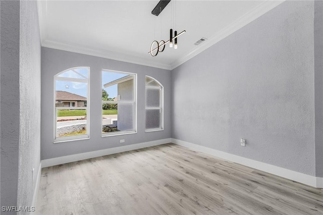 unfurnished dining area featuring ornamental molding and light hardwood / wood-style floors