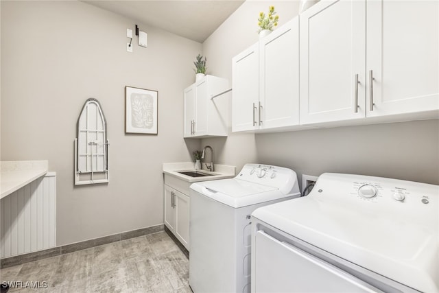 4641 Azalea Dr, Naples, FL 34119 - washroom featuring washer and clothes dryer, a sink, baseboards, light wood-style floors, and cabinet space