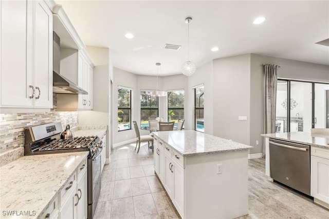 4641 Azalea Dr, Naples, FL 34119 - kitchen featuring a center island, backsplash, visible vents, appliances with stainless steel finishes, and wall chimney exhaust hood
