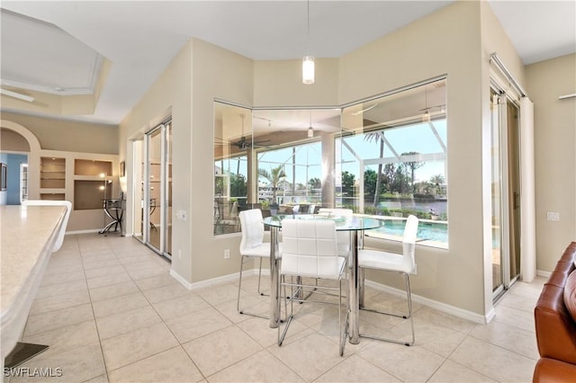 dining area featuring light tile patterned floors and built in features