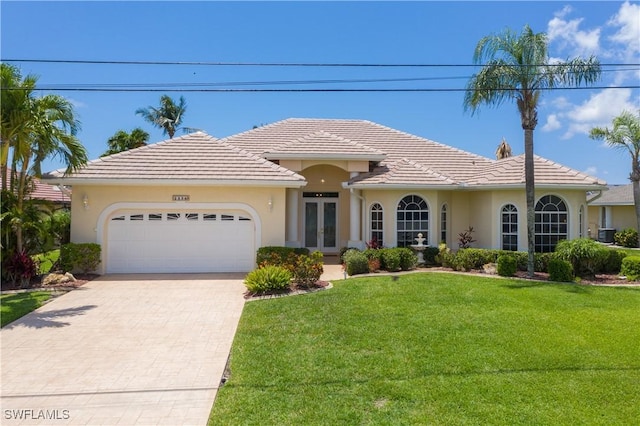 view of front of property with a garage, a front lawn, and french doors