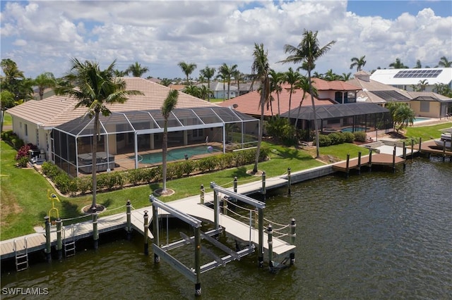 view of dock with a water view, a lanai, and a lawn