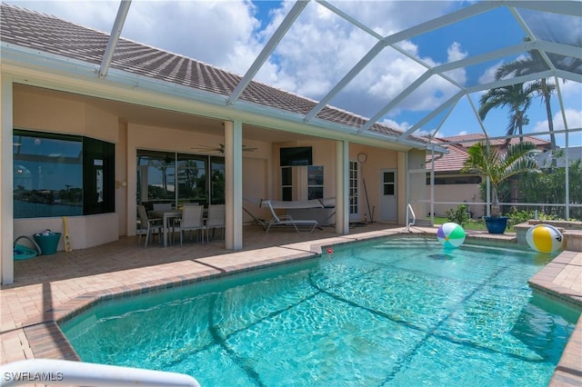 view of swimming pool featuring a patio, a lanai, and ceiling fan