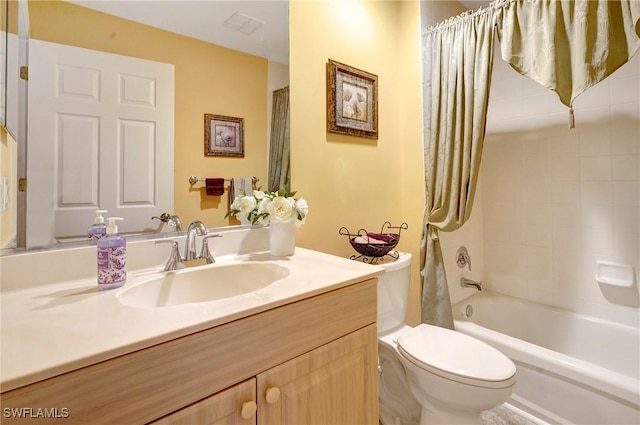 full bathroom with vanity, shower / tub combo with curtain, and toilet