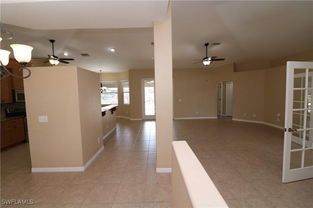 interior space with french doors and ceiling fan with notable chandelier