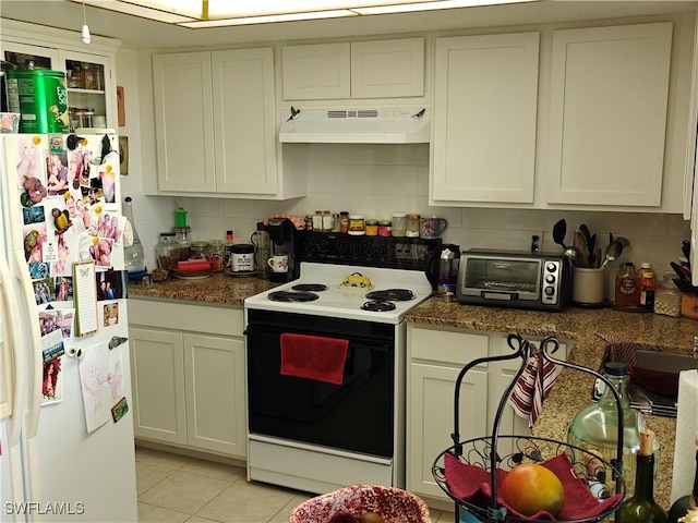 kitchen featuring light tile patterned floors, range with electric stovetop, white fridge with ice dispenser, dark stone counters, and decorative backsplash