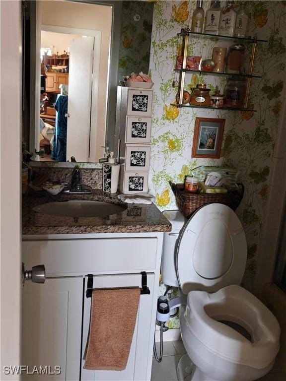 bathroom featuring vanity and toilet