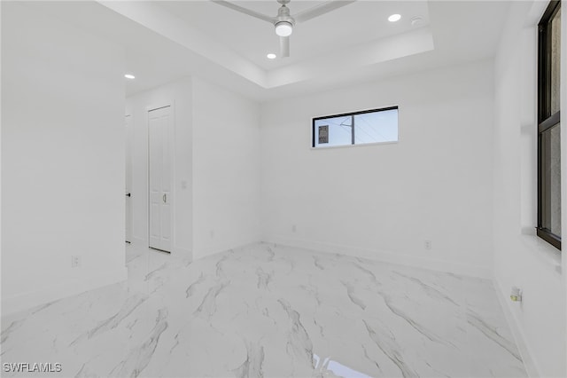 empty room featuring a tray ceiling