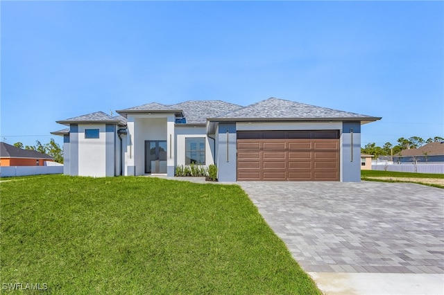 view of front of house with a garage and a front lawn