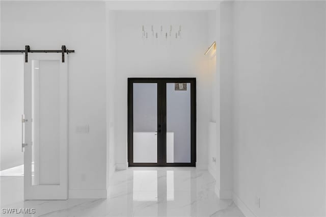 corridor featuring french doors and a barn door