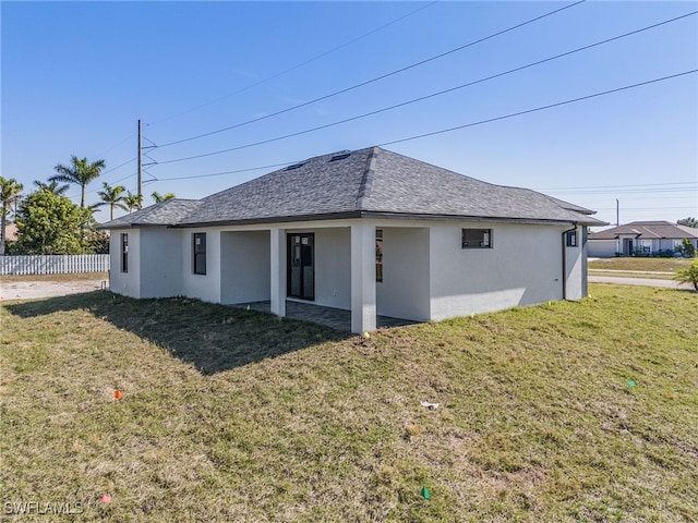 back of house with a lawn