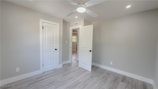 unfurnished bedroom with ceiling fan and light wood-type flooring