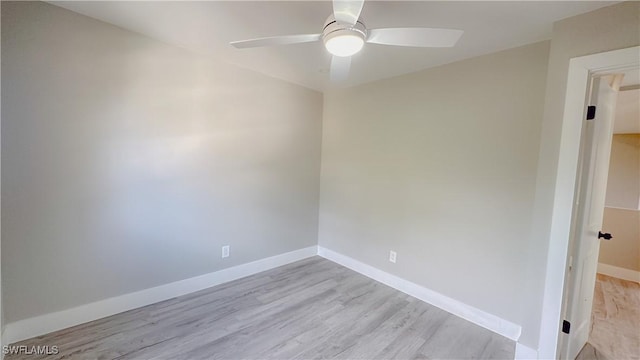 empty room with ceiling fan and light hardwood / wood-style floors