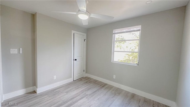 unfurnished room with ceiling fan and light wood-type flooring