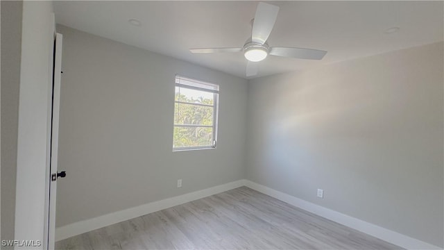 empty room with ceiling fan and light hardwood / wood-style flooring