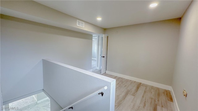 hall with hardwood / wood-style floors